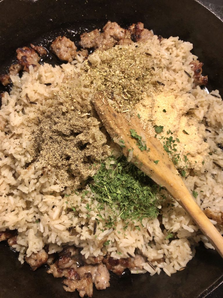 wild rice with Italian sausage and herbs being added