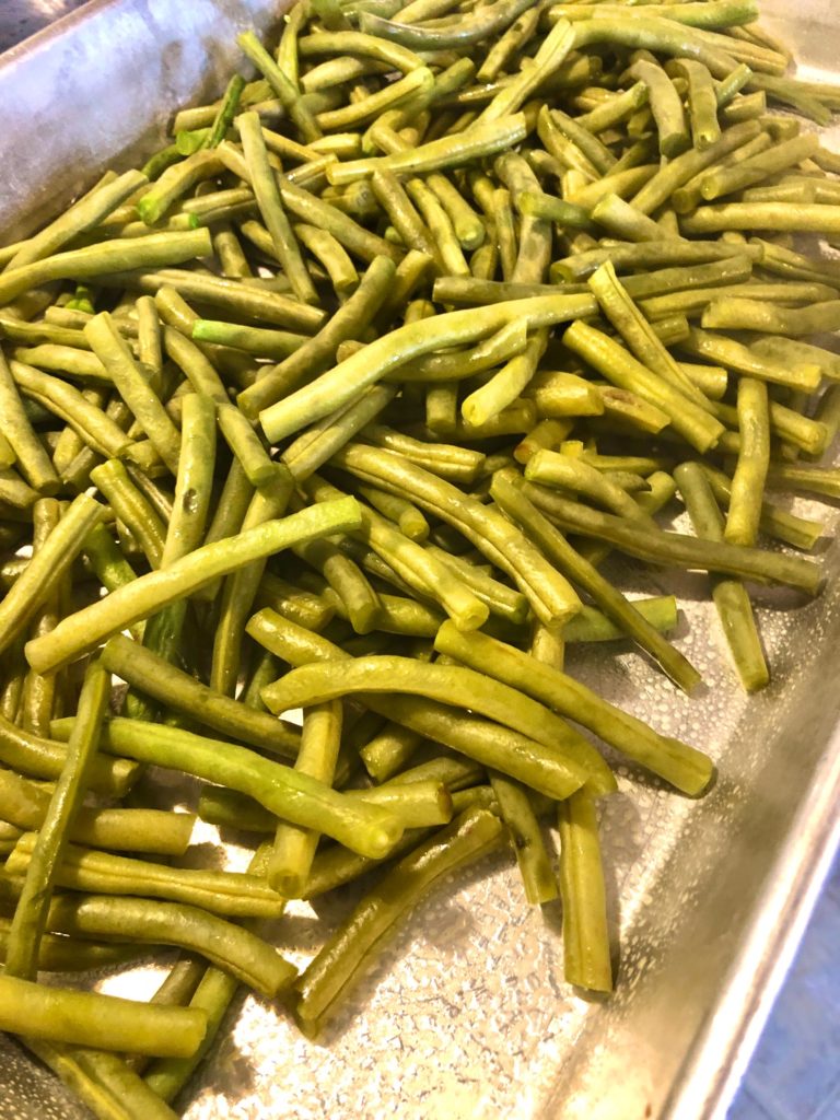 cooked green beans, drained and added to silver baking pan