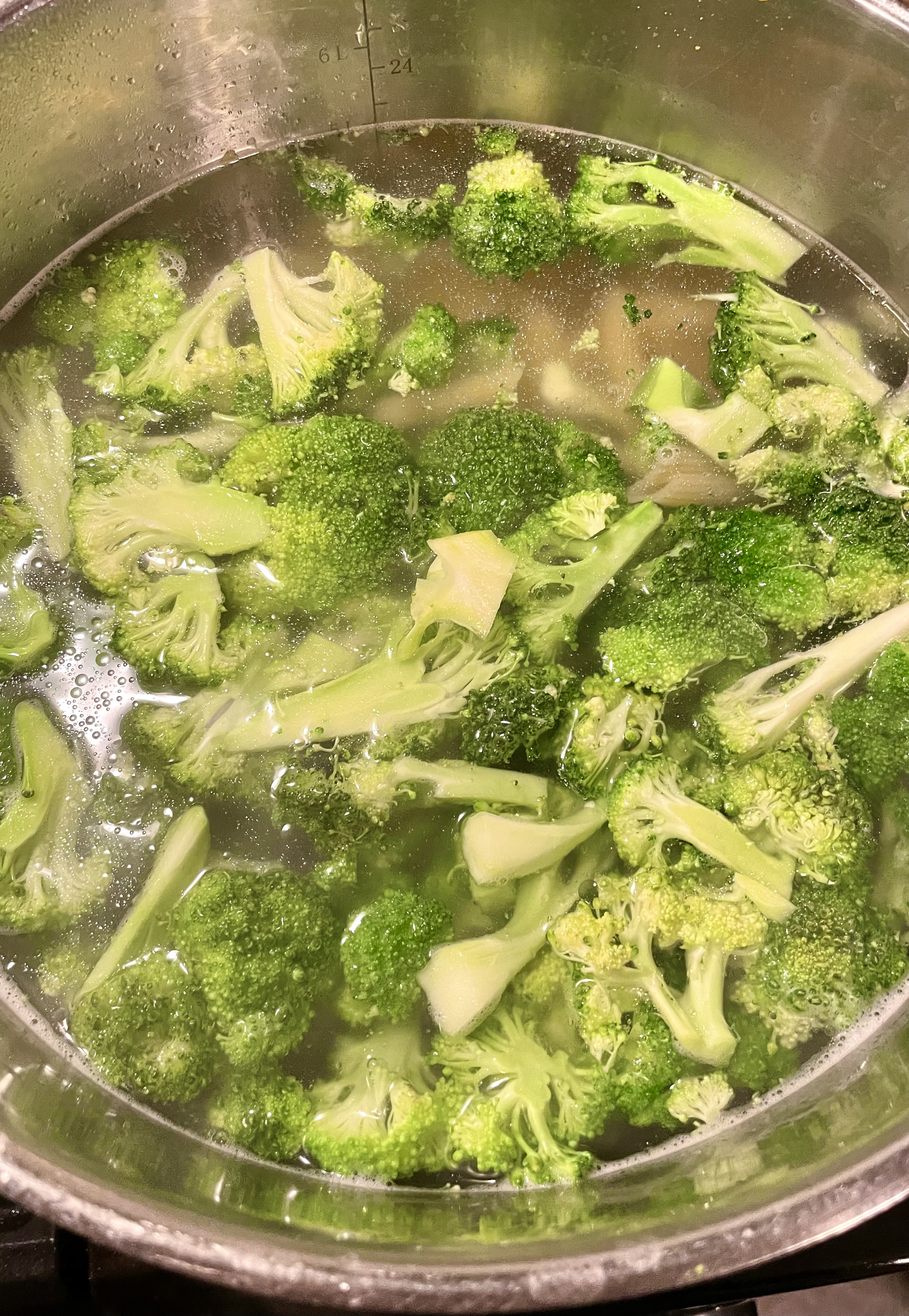 Broccoli added to boiling pasta water close to the end of the pasta cooking.