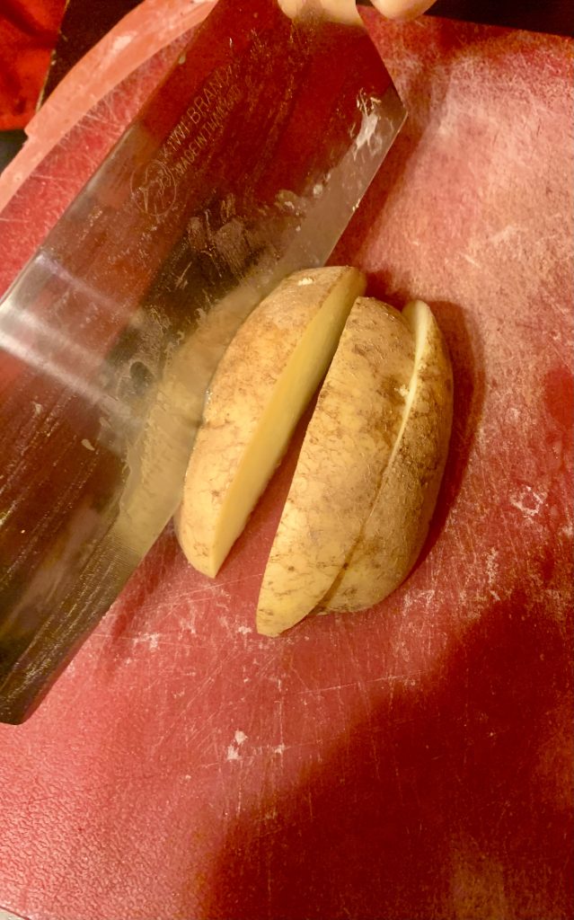 slicing potato in wedges