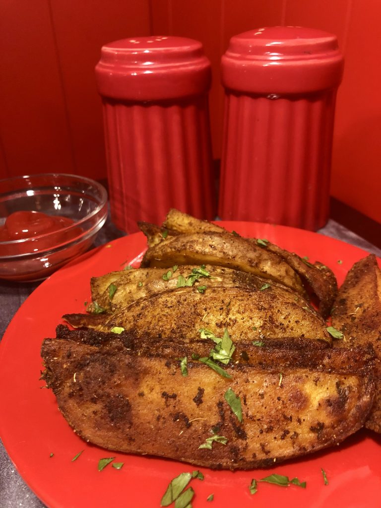 spicy potato wedges plated and garnished
