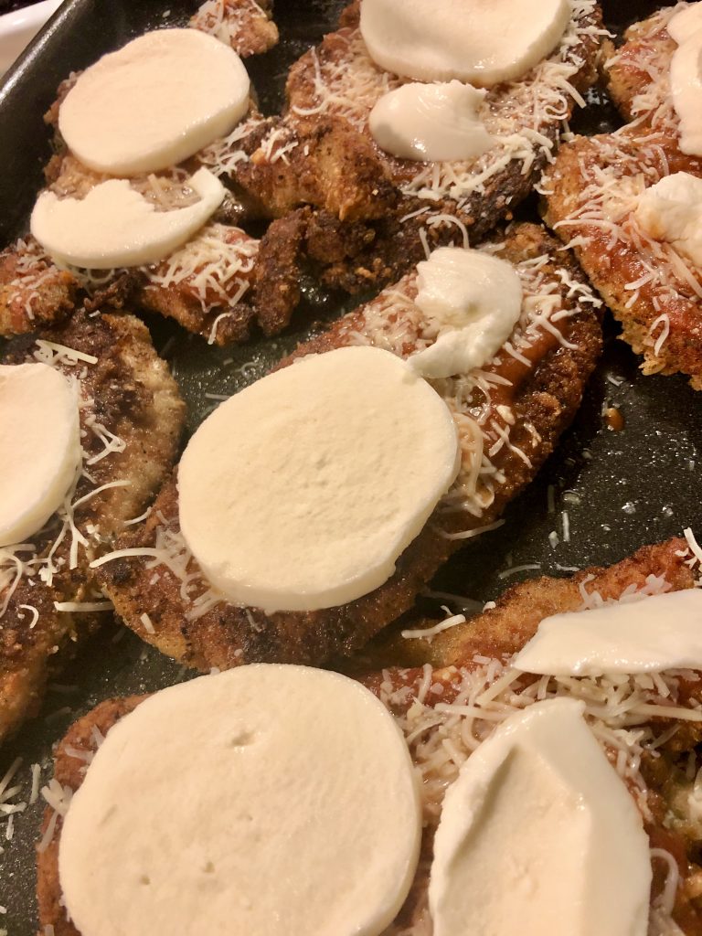chicken parmesan with fresh mozzarella on pan before baking