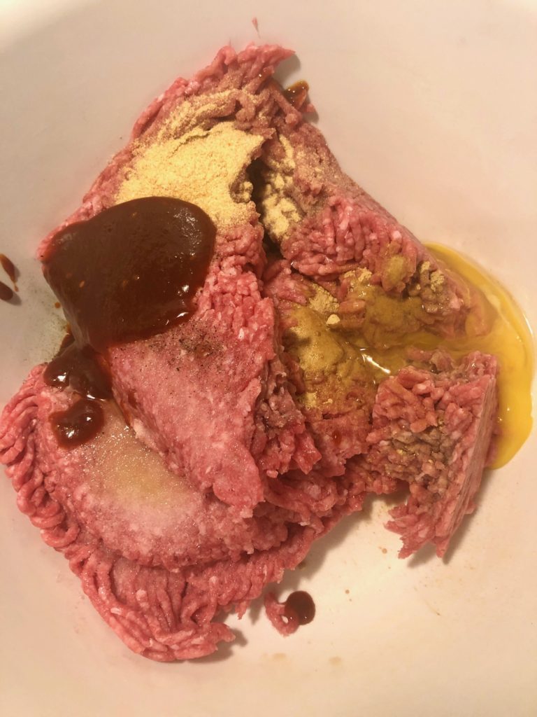 ground beef, panko crumbs, gochujang, sesame oil, egg in white mixing bowl