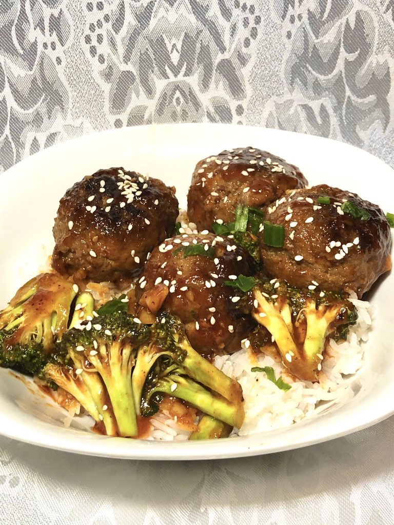 korean meatballs with gochujang sauce, broccoli, white rice and sesame seeds