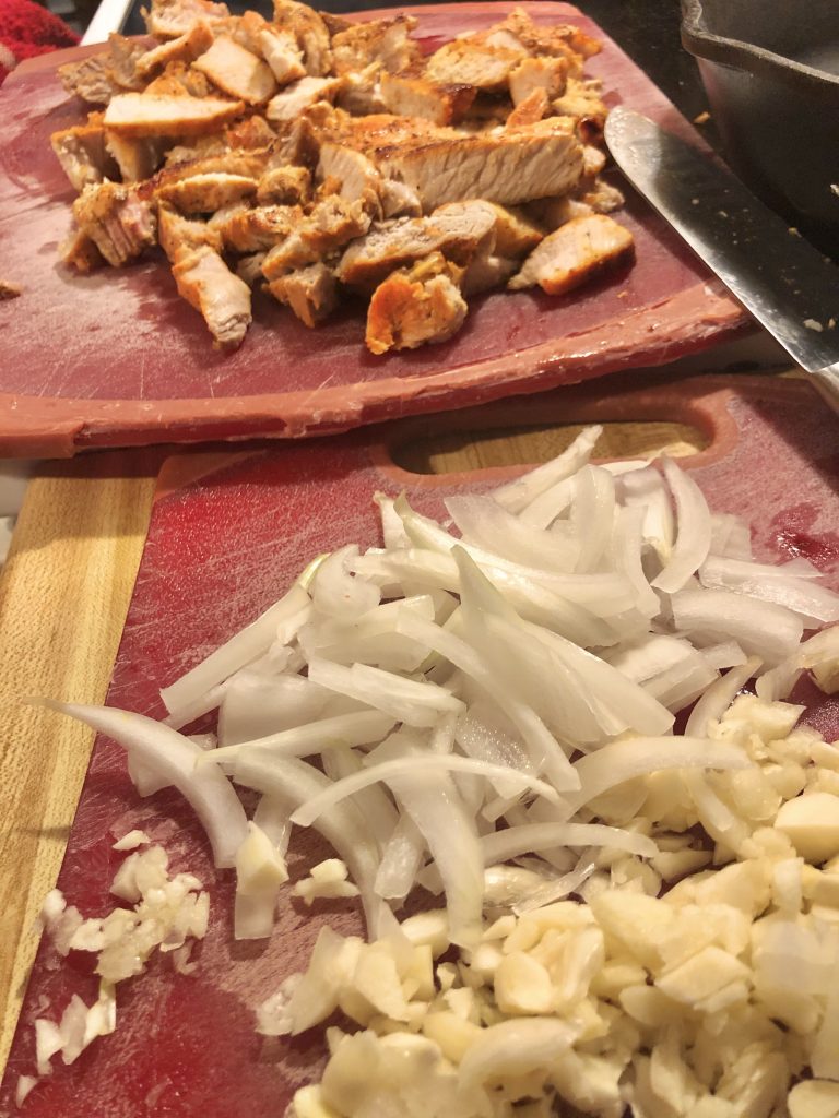 sliced pork onion garlic on cutting boards