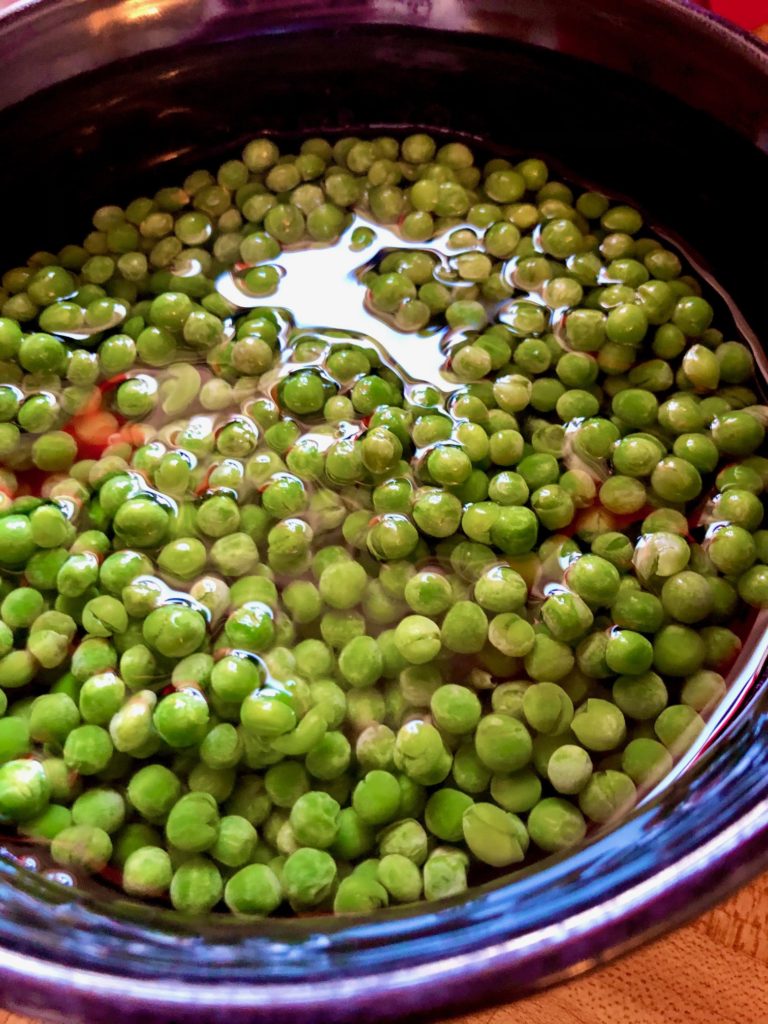 peas covered with water in bowl