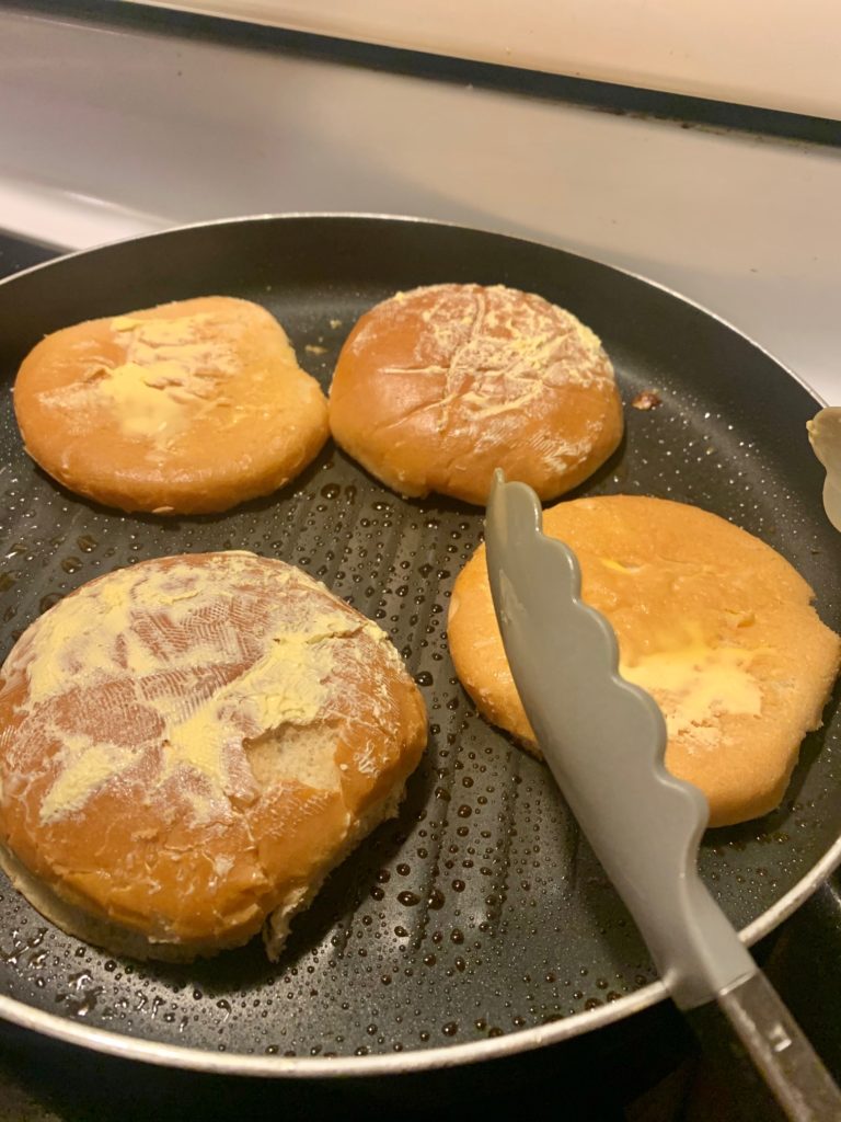 grilling hamburger buns in grill pan