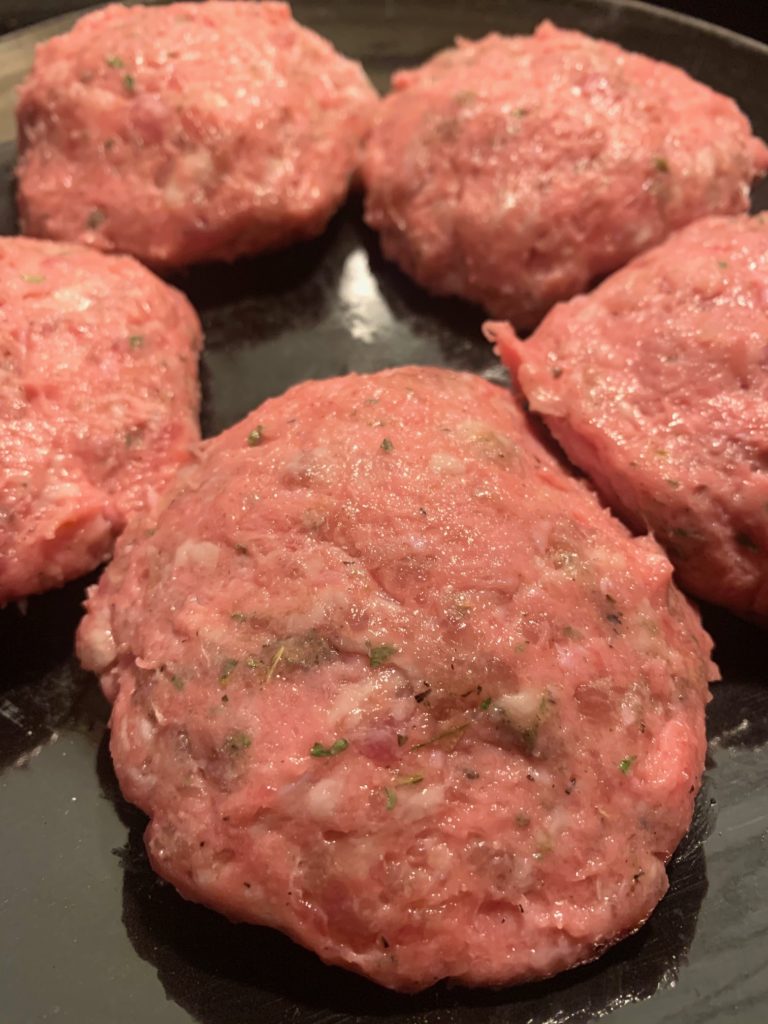 california sausage turkey burger patties formed on black plate