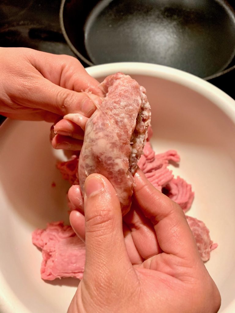 Removing sweet Italian sausage links from their casing