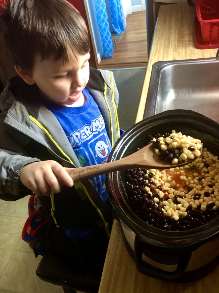 Dylan helping cook slow cooker mexican shredded chicken
