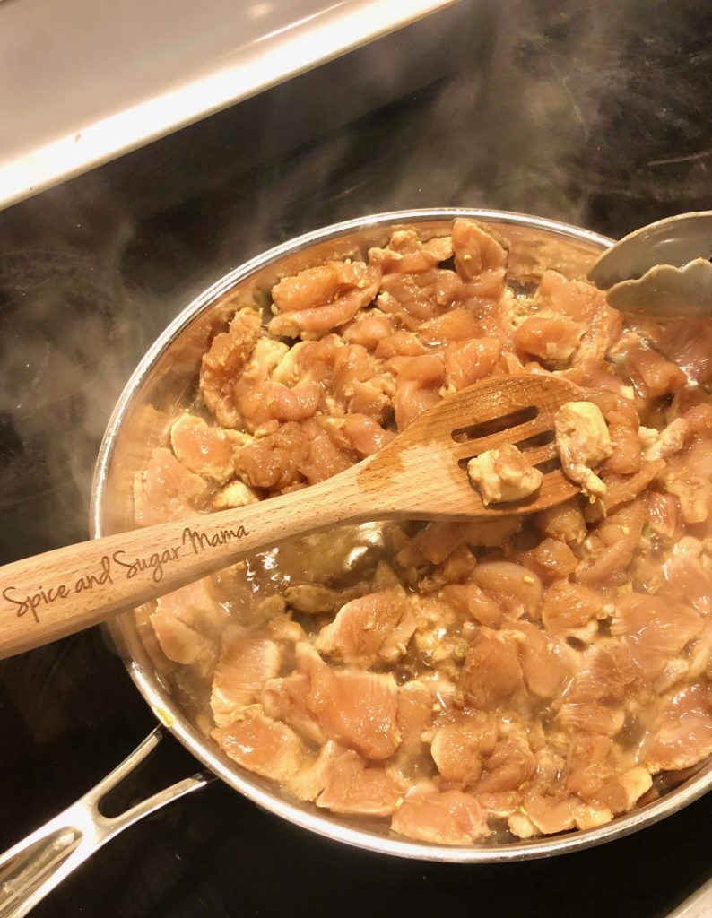 marinated boneless skinless chicken frying in pan