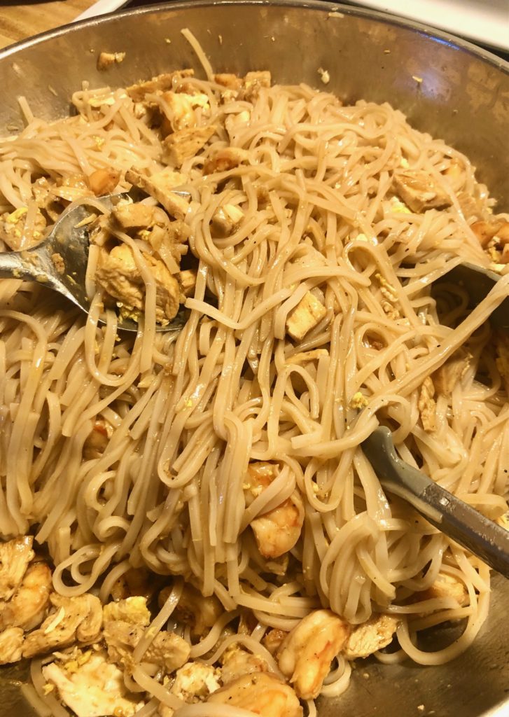 pan frying pad thai noodles with chicken and shrimp