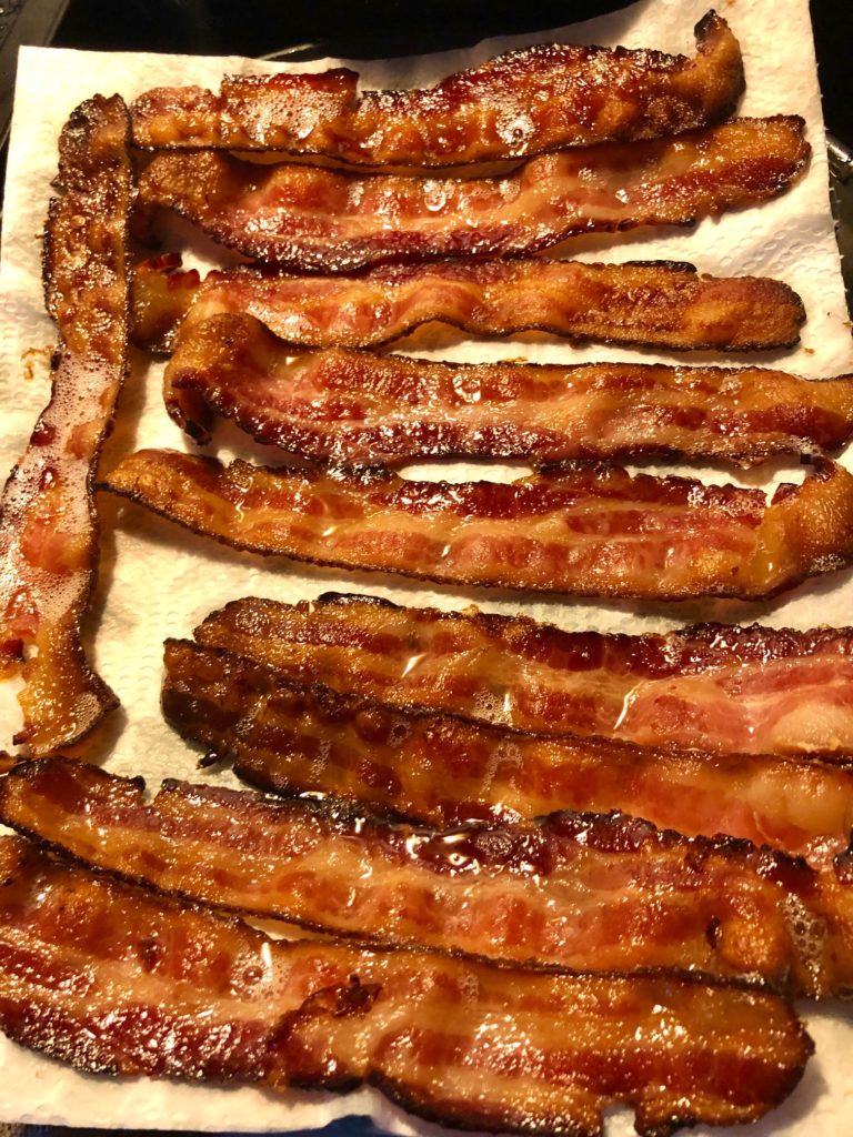 crispy cooked bacon on paper towel lined plate