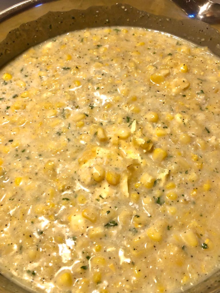 corn chowder simmering in silver pan