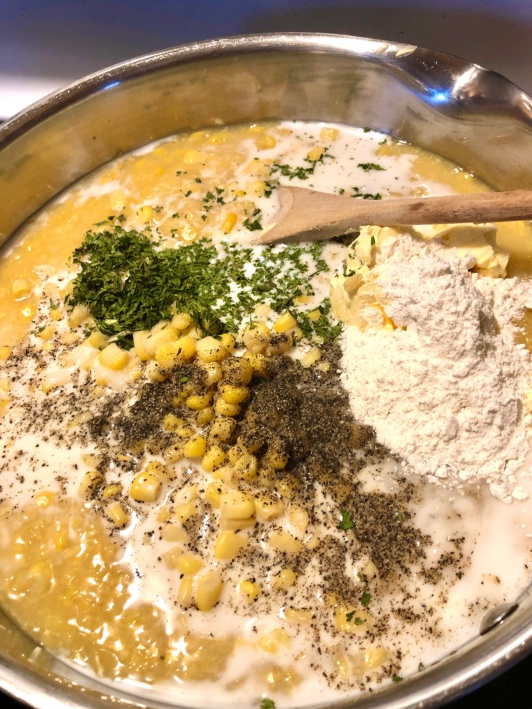 corn chowder, flour, black pepper, dried parsley, milk and butter simmering in silver pot