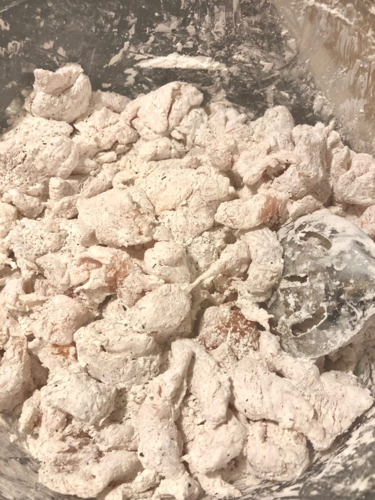 sliced boneless skinless chicken breast in corn starch with salt and pepper breading