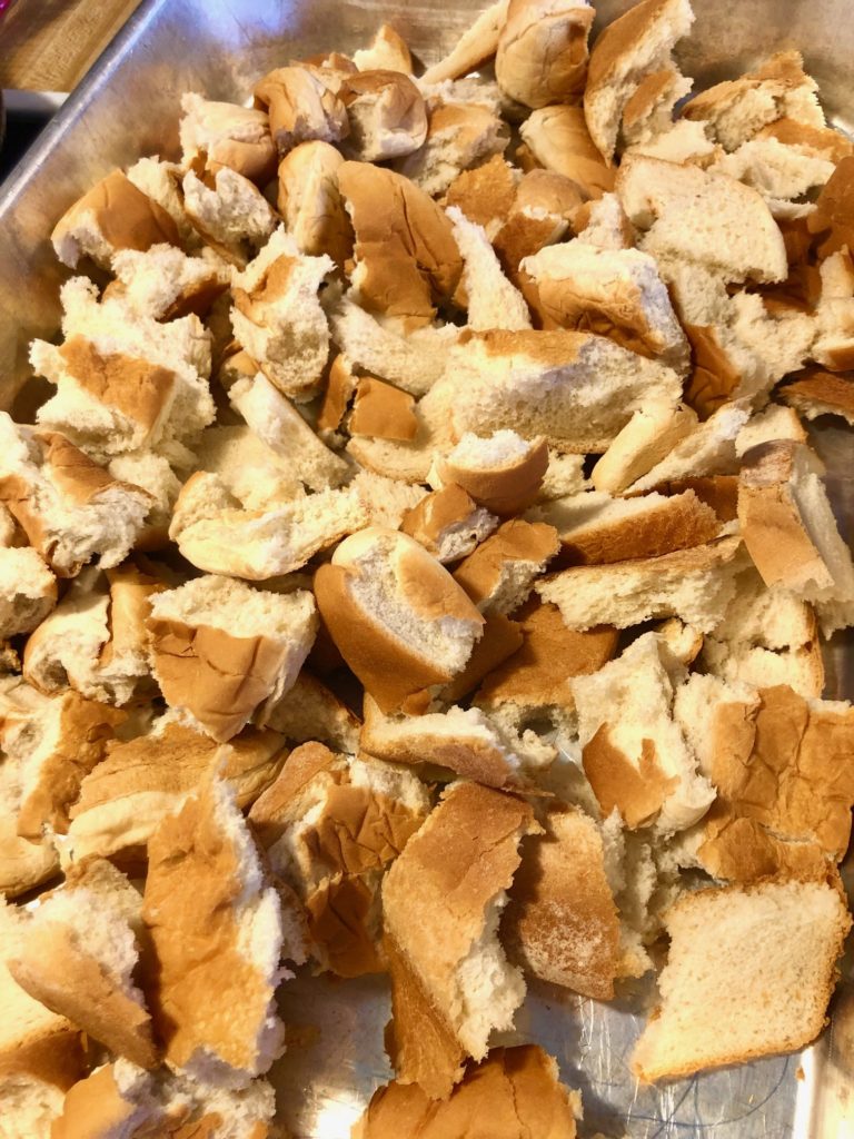 hamburger buns, hotdog rolls and leftover bread torn into two inch pieces in silver baking dish