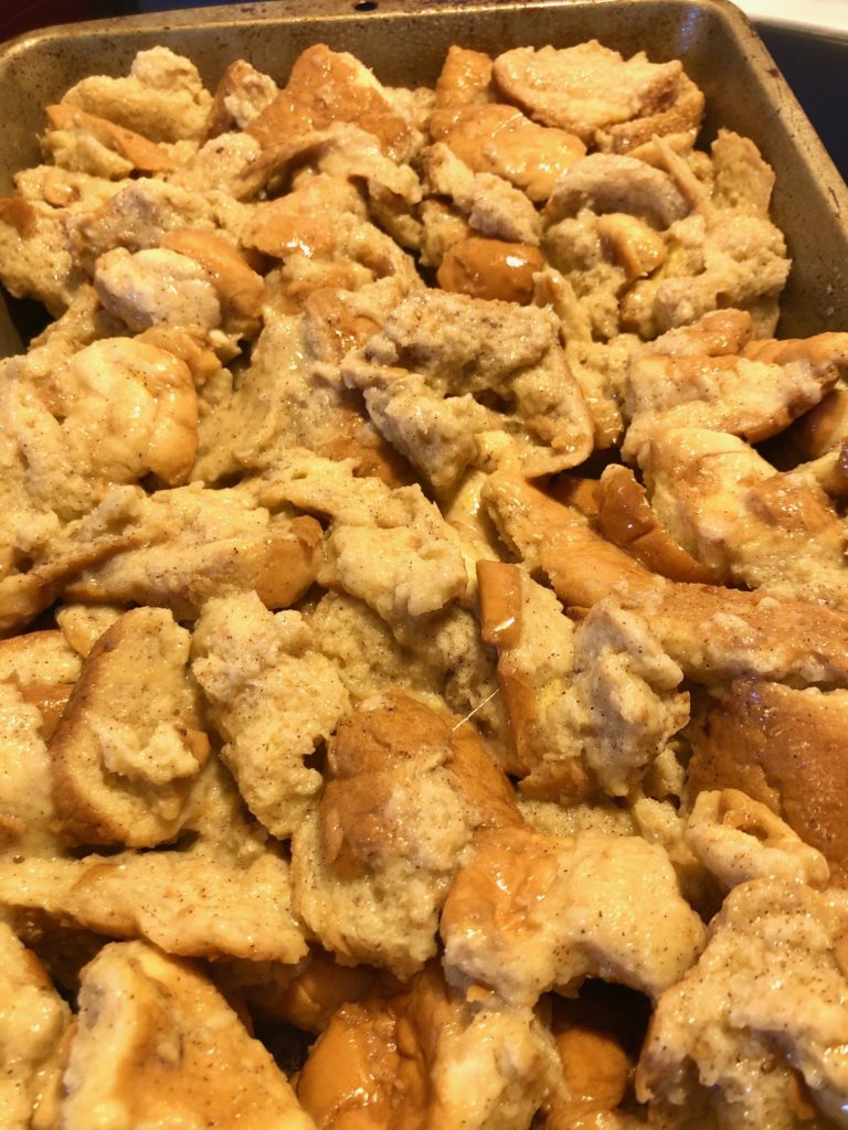 french toast casserole pictured before baking in silver baking pan