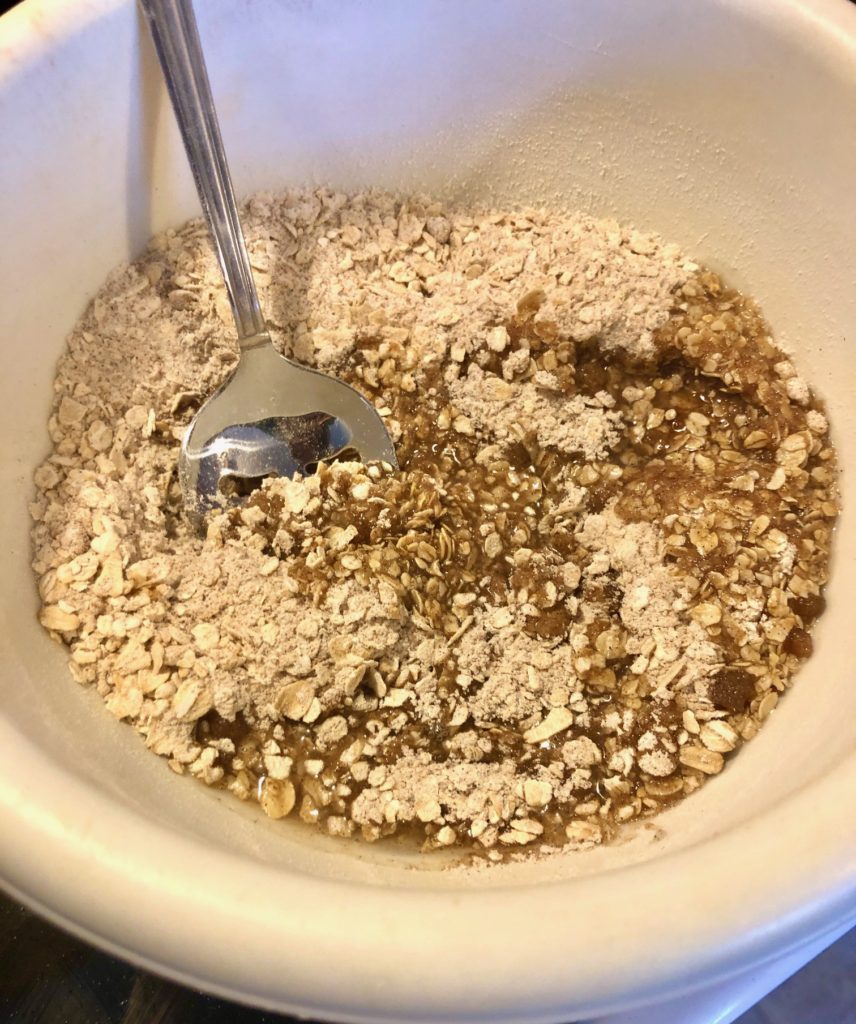 oats, flour, sugar, brown sugar, cinnamon and salt with vegetable oil in medium white mixing bowl