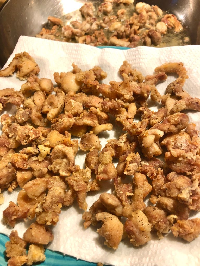 fried boneless skinless chicken coated in cornstarch on paper towel lined plate