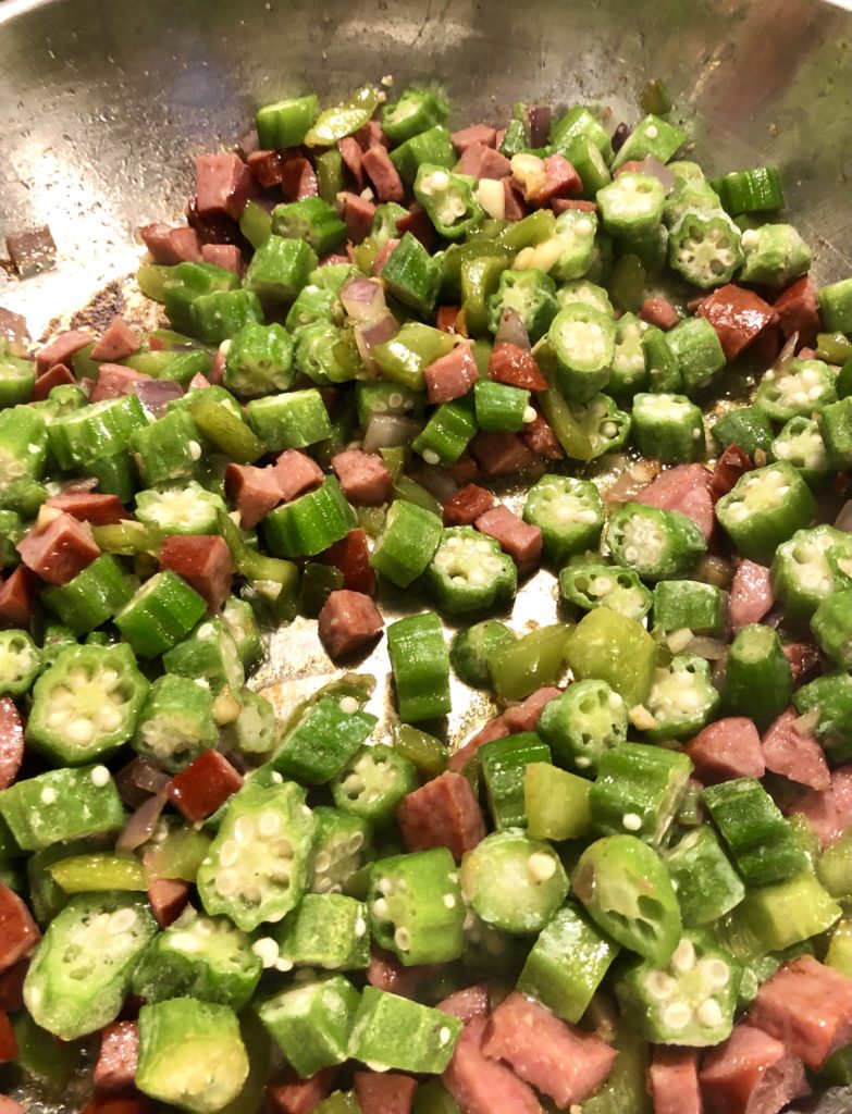 kielbasa, green pepper and okra frying in skillet