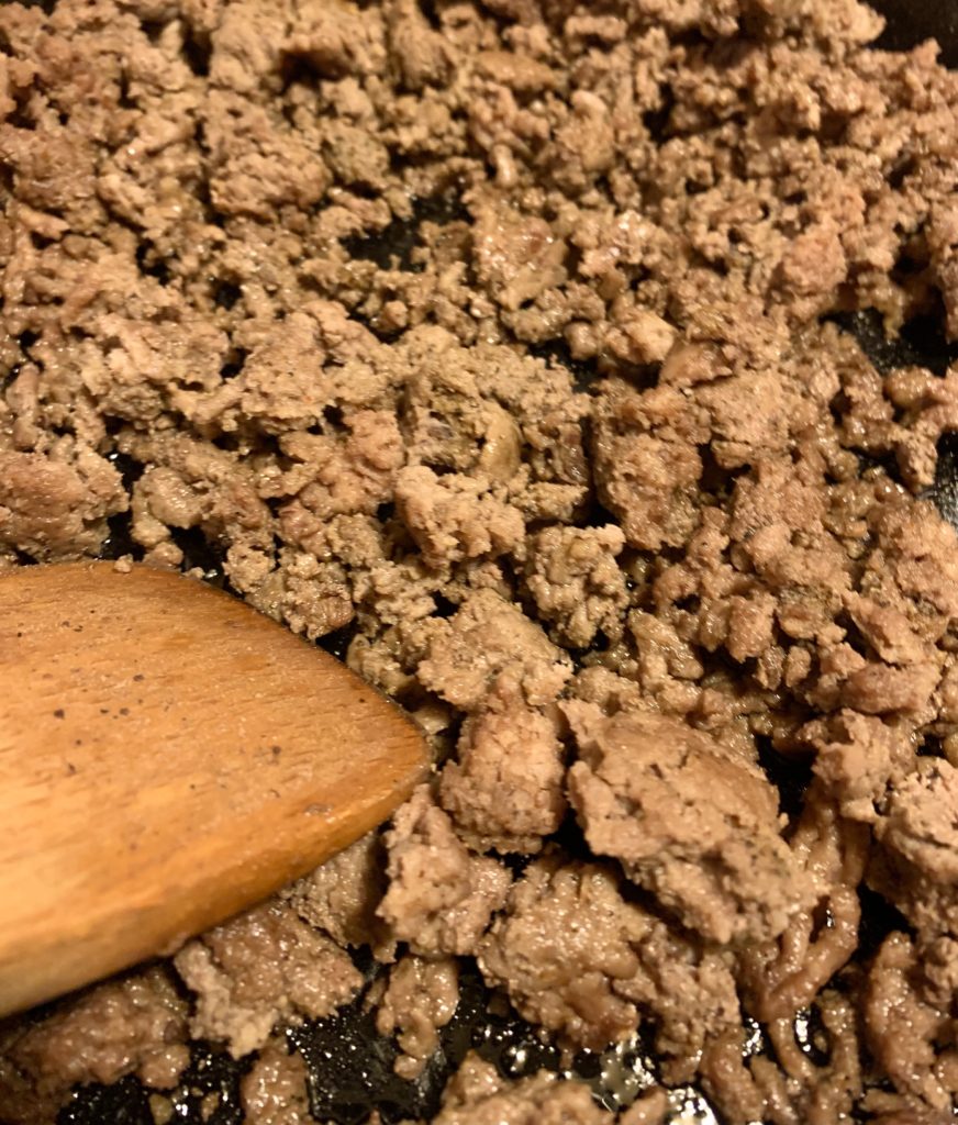 cooking ground beef in cast-iron skillet