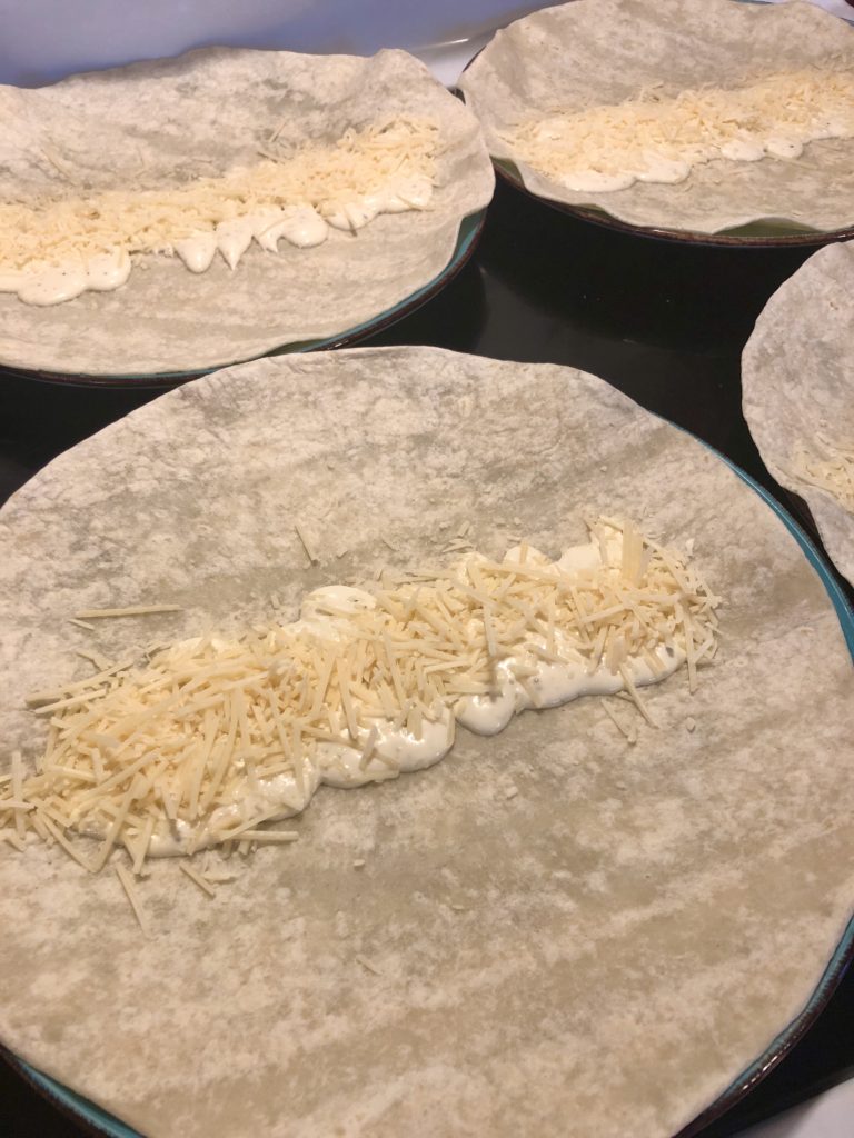 flour tortilla wrap with creamy Caesar dressing and shredded parmesan cheese