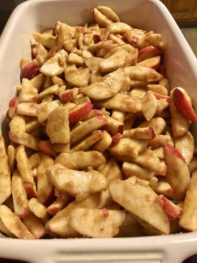 apples in cinnamon, sugar, flour, lemon juice added to baking dish