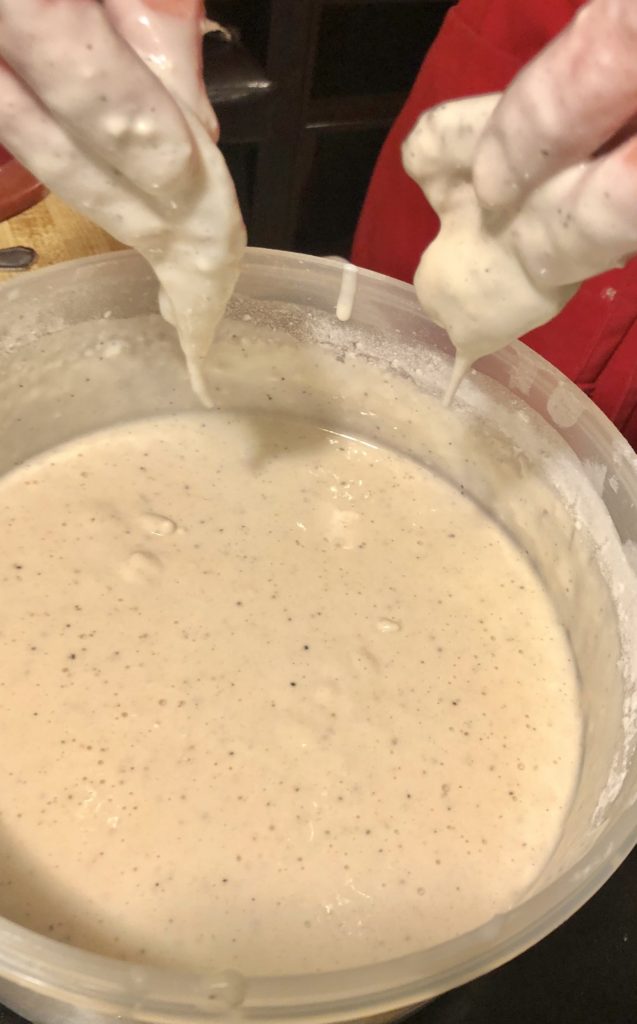 dipping shrimp in batter for Chinese fried shrimp