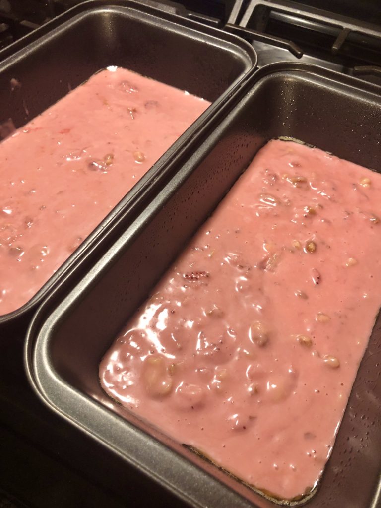 strawberry and walnut bread batter added to two loaf pans
