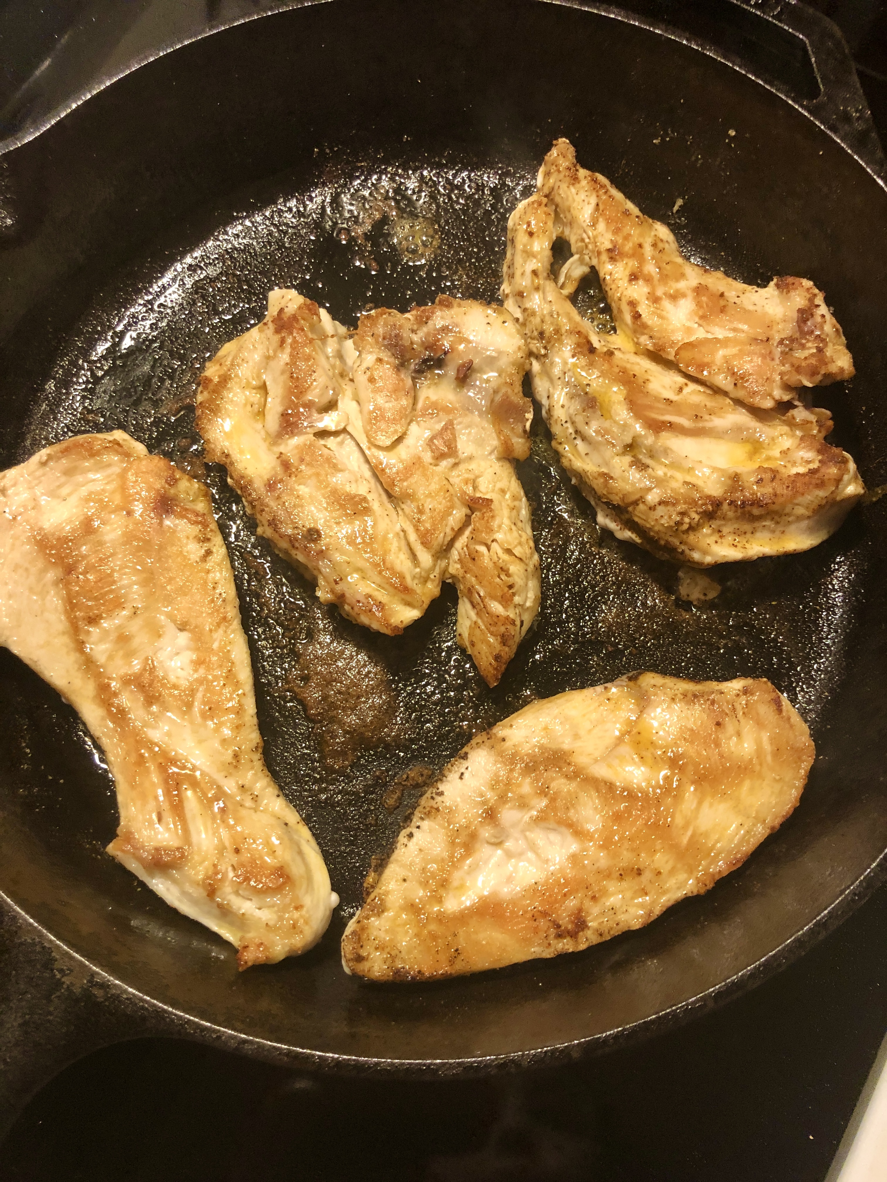 chicken cooking and flipped in skillet