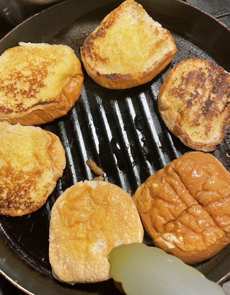 Grilled hamburger buns in grill pan.