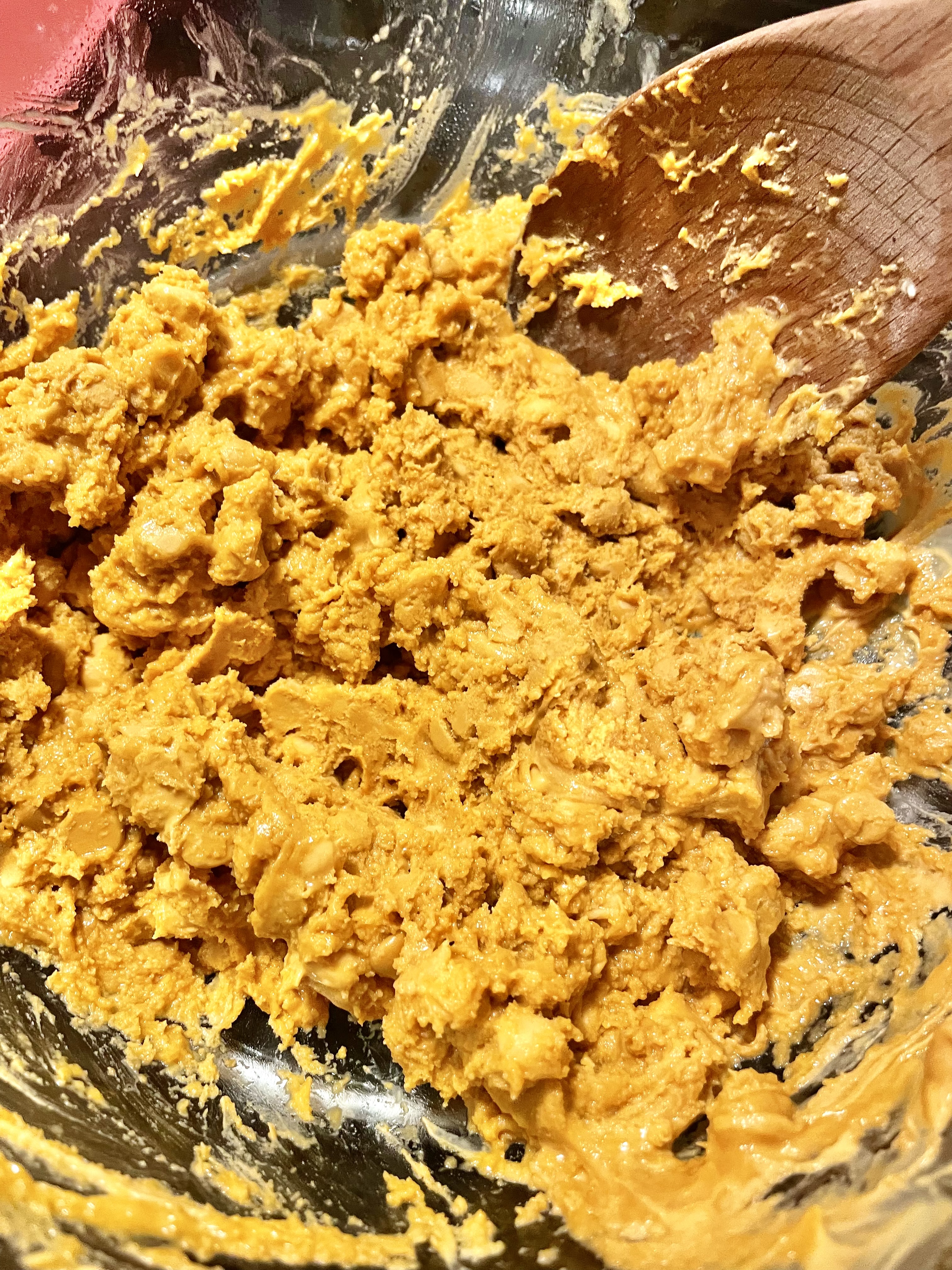 Butterscotch chips melting in stovetop double boiler with melted butter and vanilla extract.