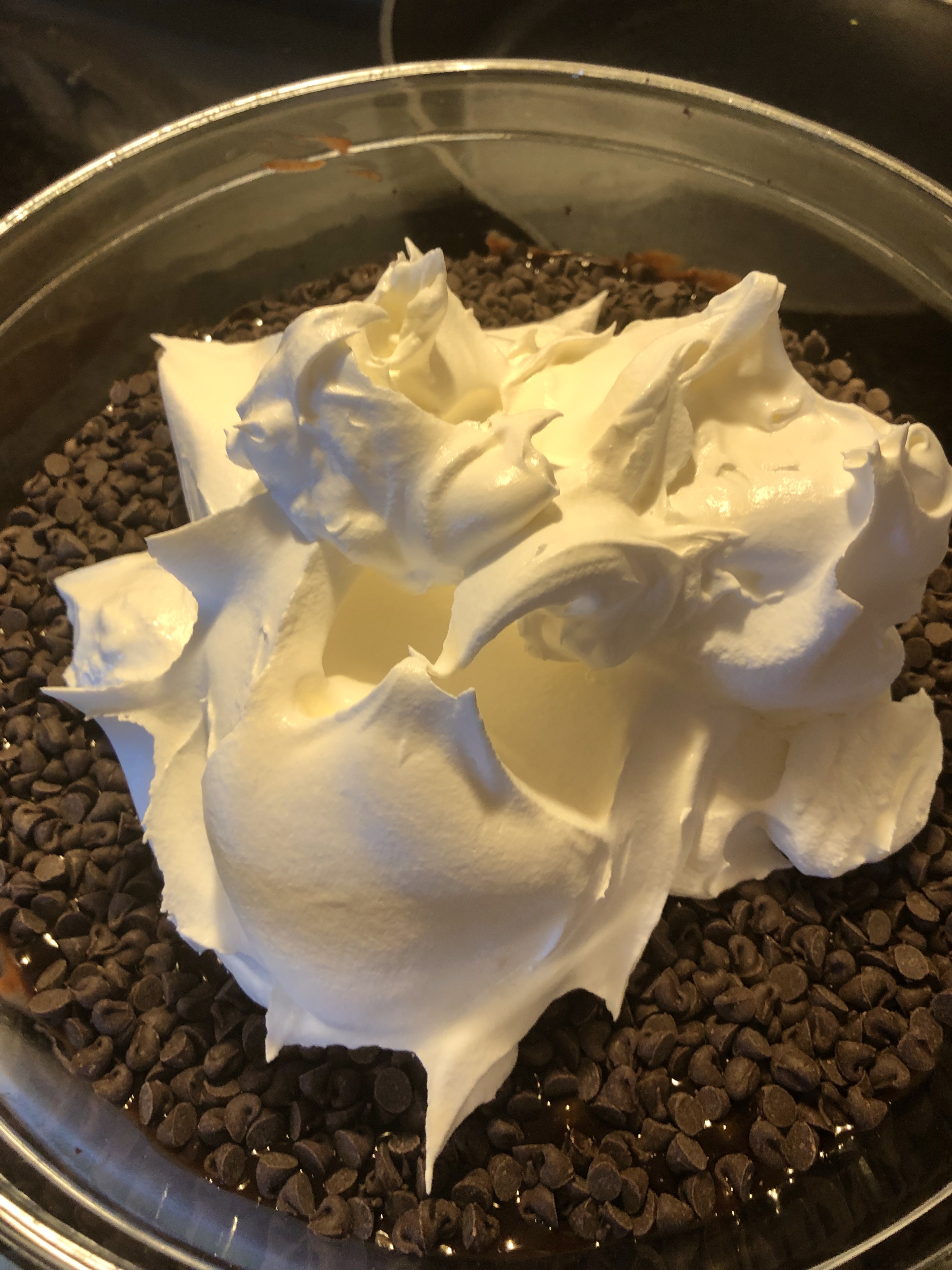Cool Whip being added to the top of the Dirt Cake.