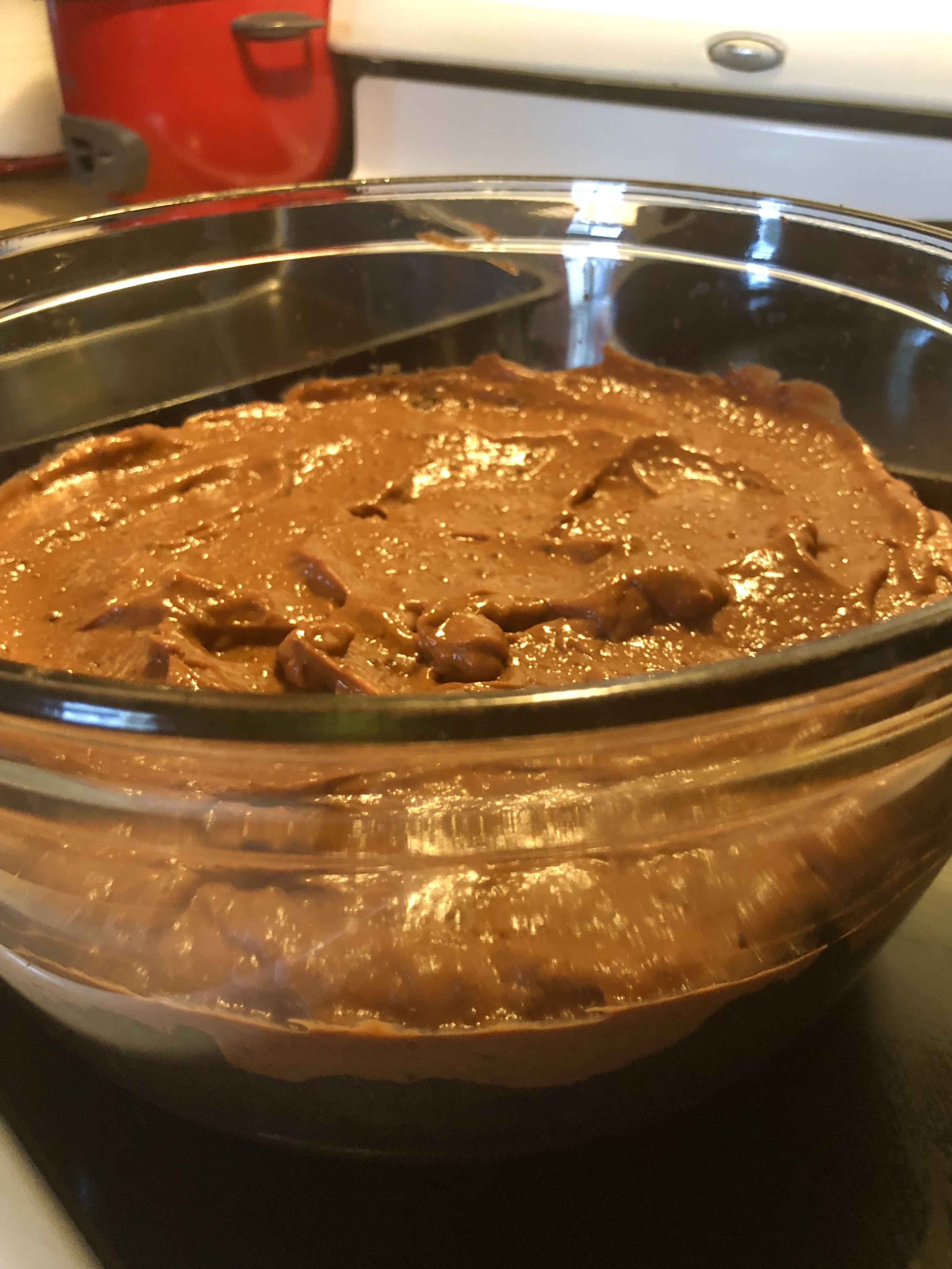 A trifle dish showing chocolate pudding layered over chocolate cake.