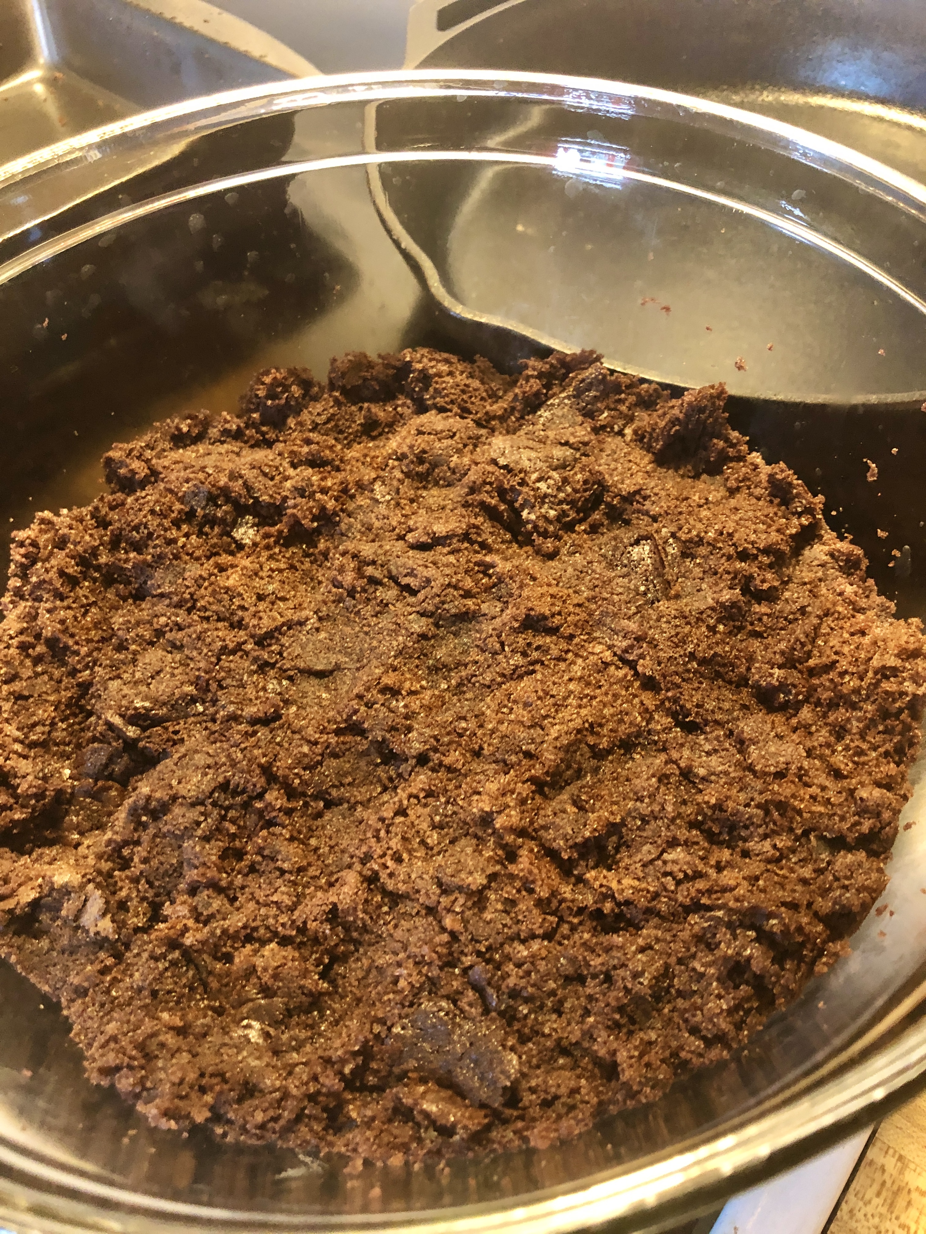 Chocolate cake broken apart and pushed down into the bottom of a trifle bowl for the base of the Dirt Cake.