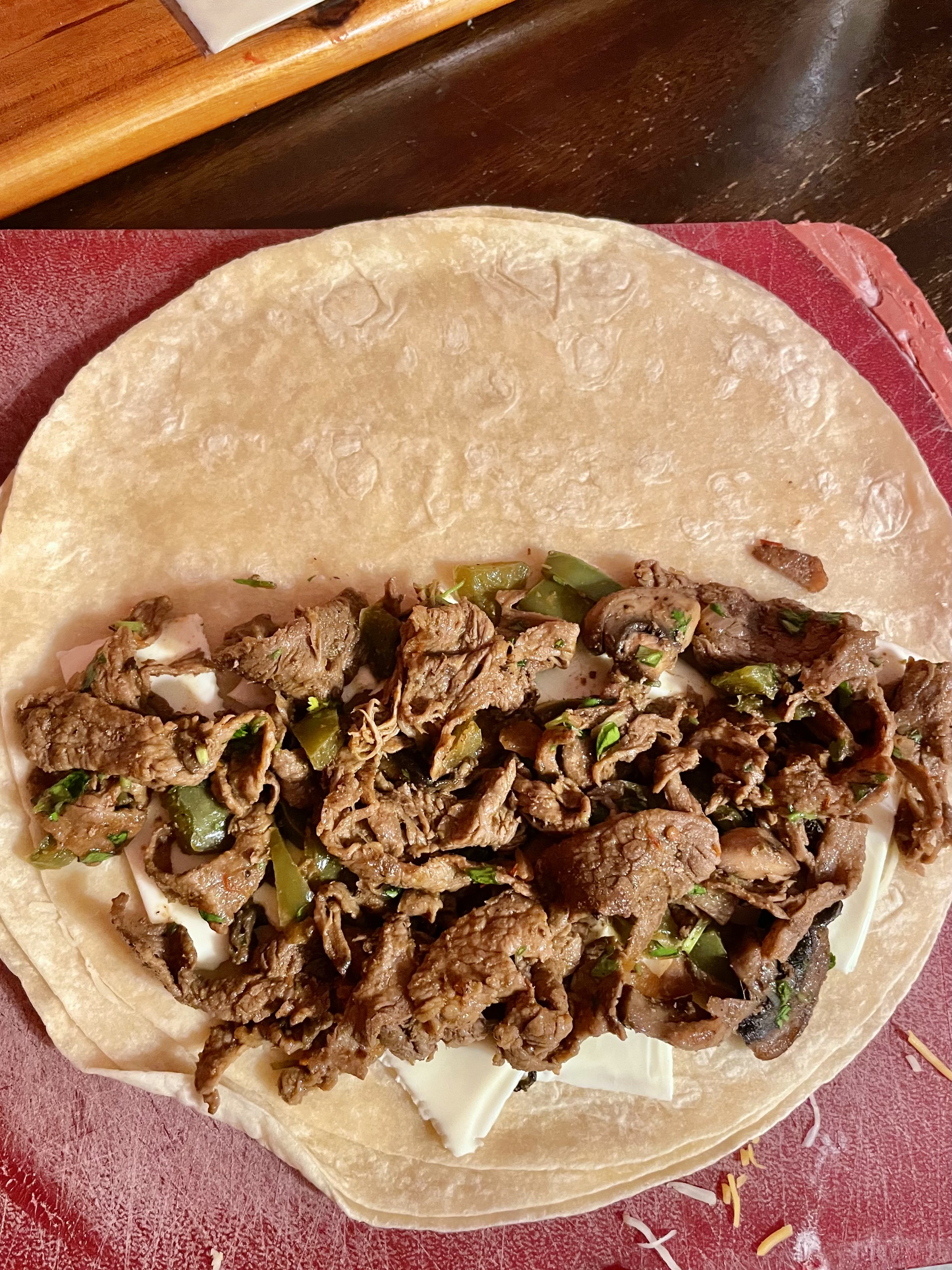 Flour tortilla with American cheese and steak bomb filling.