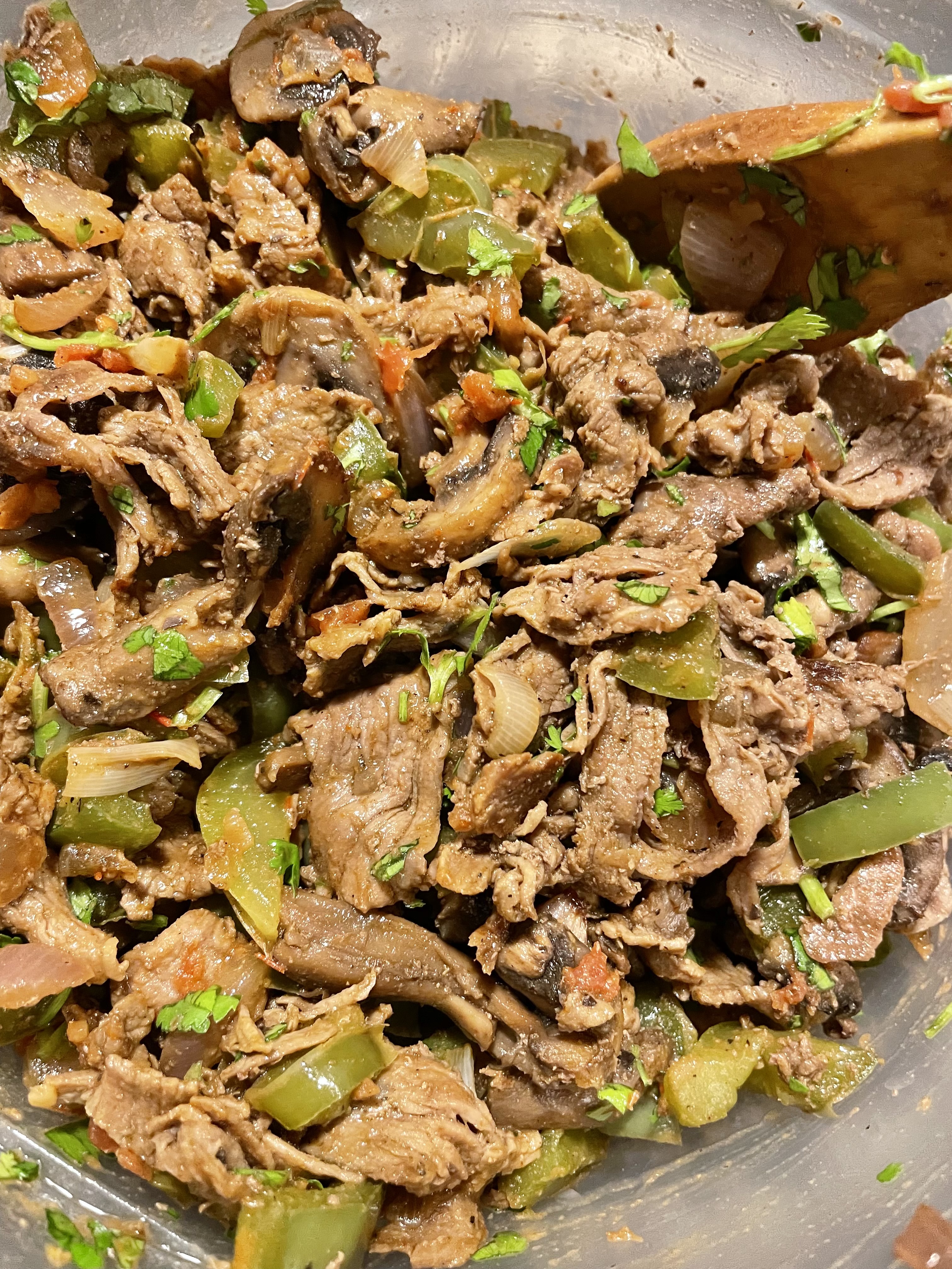Steak bomb quesadilla filling mixed together in bowl with cilantro and salsa.