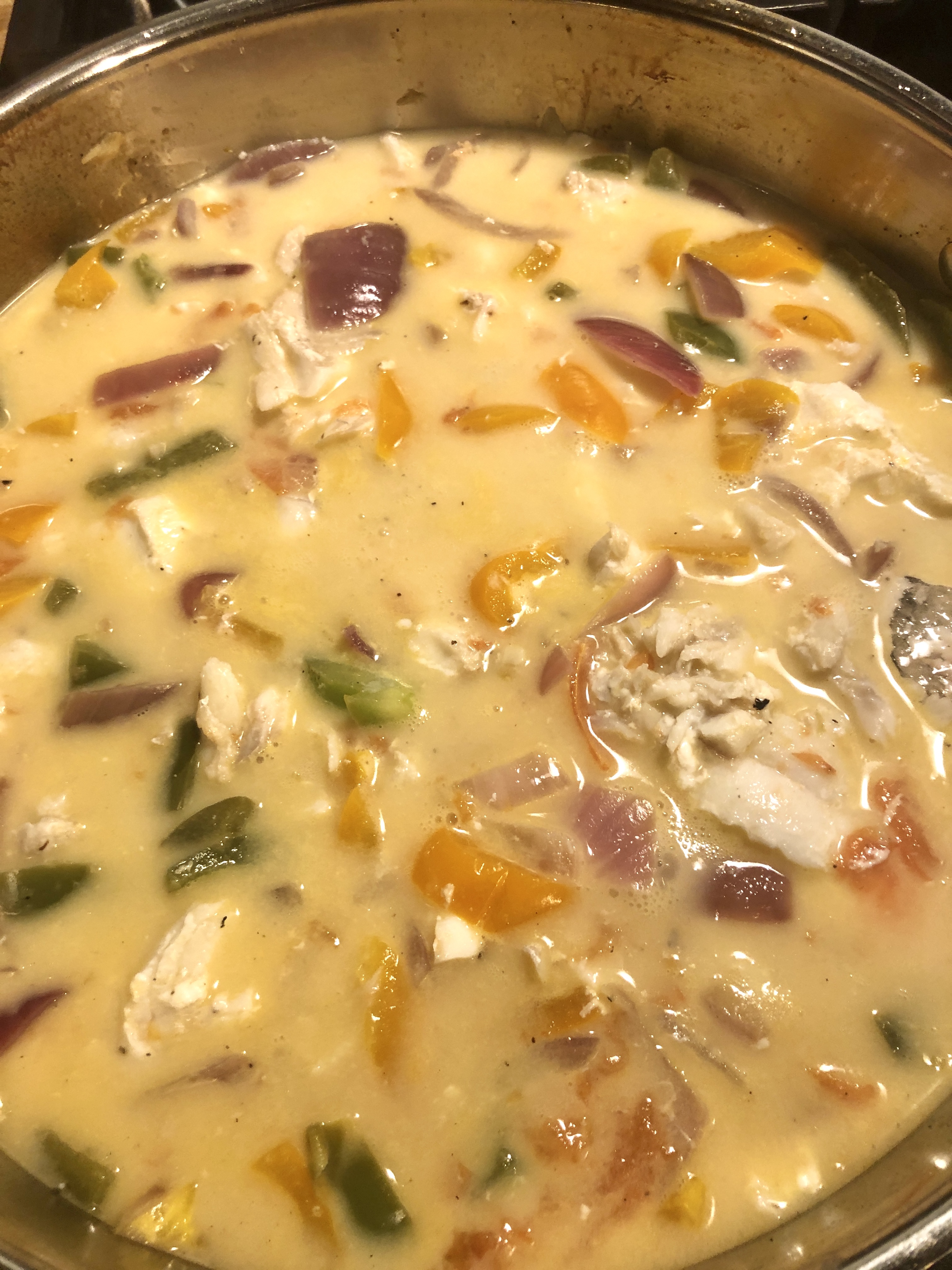 Moqueca beginning to stew after the coconut milk has been added.