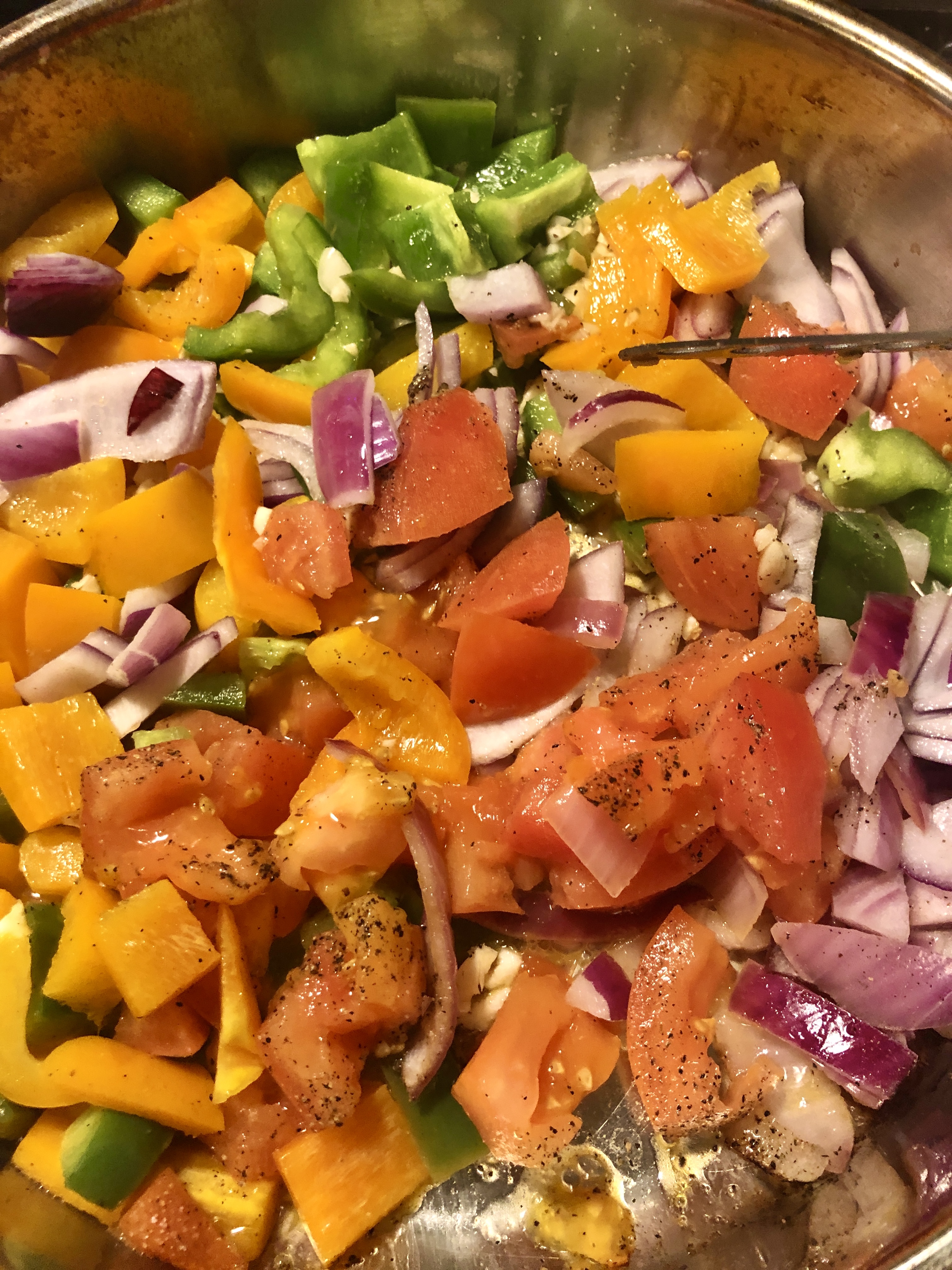 Seasoning frying vegetables in frying pan.