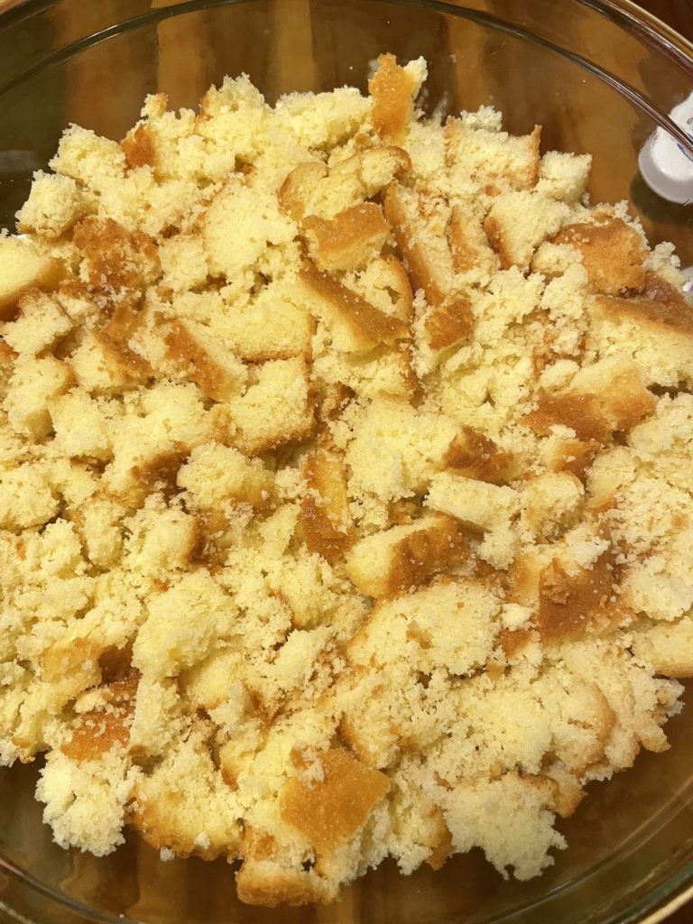 Broken apart store bought pound cake in a trifle dish.