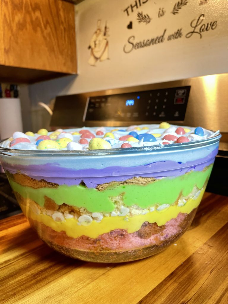 Side view of the Easter trifle bowl with colorful layers visible.